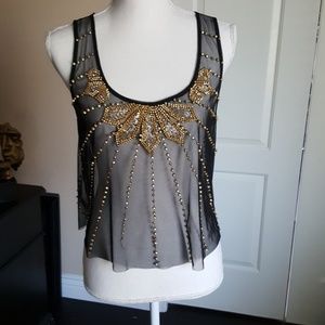 Sheer black top with gold accents.